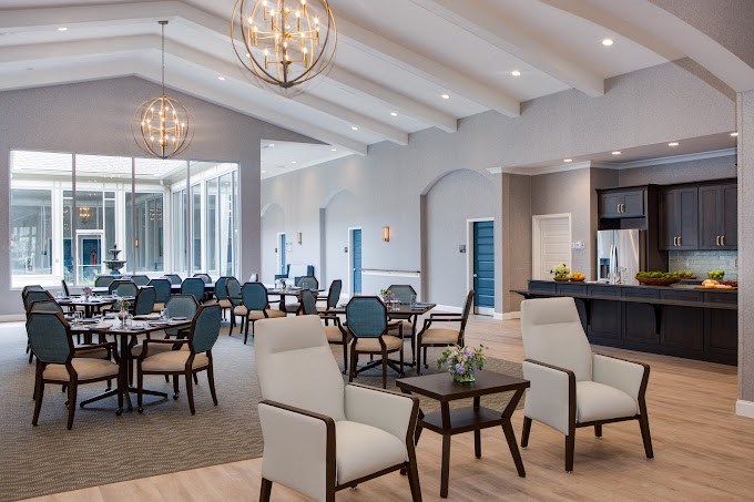 A modern dining area with elegant chandeliers and comfortable seating.