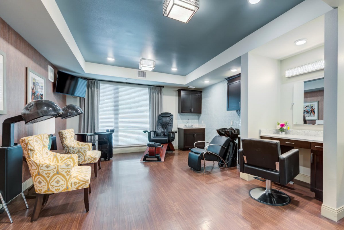 Modern beauty salon interior with styling chairs and equipment.