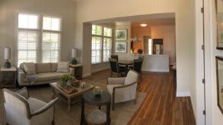 A spacious open-concept living and dining area featuring modern furniture and abundant natural light.