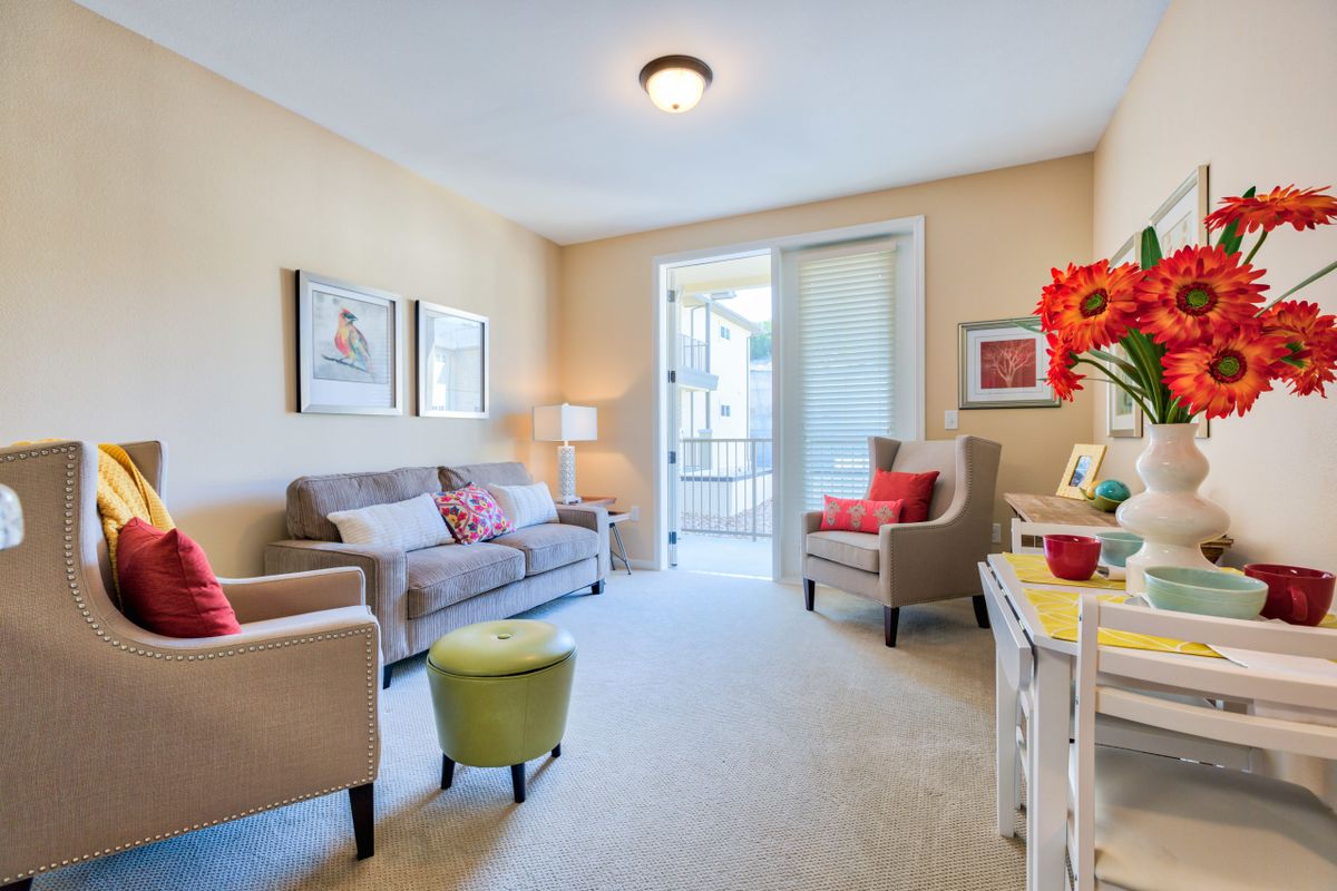 A modern living room with comfortable seating and colorful decor.