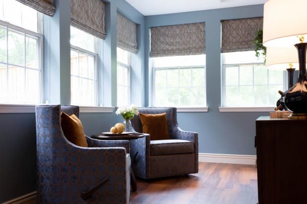 A cozy seating area with two armchairs and a small coffee table by the window.