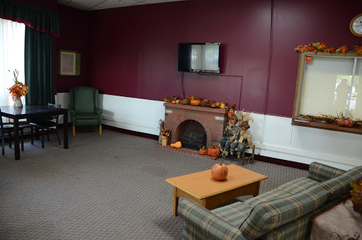 A cozy living room setting featuring a fireplace, television, and comfortable seating.