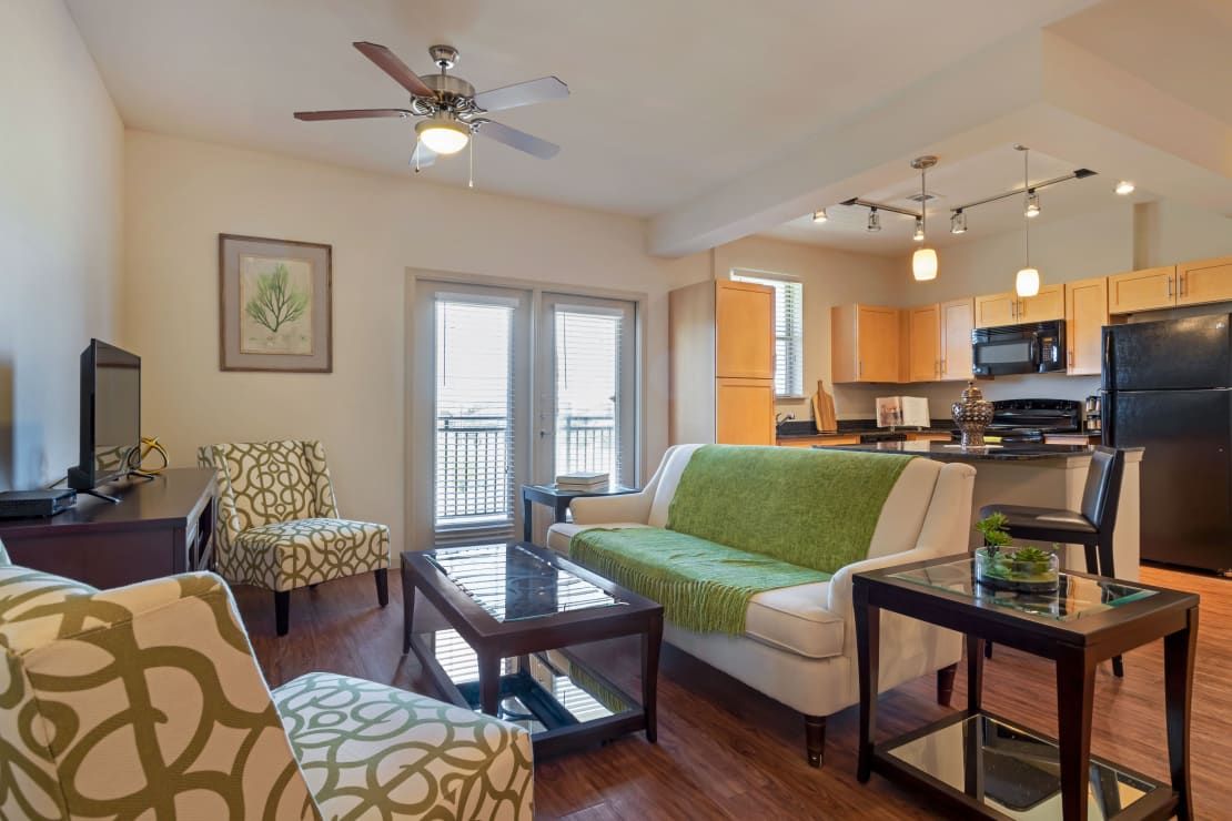 A modern living room with an open floor plan, featuring comfortable seating and stylish decor.
