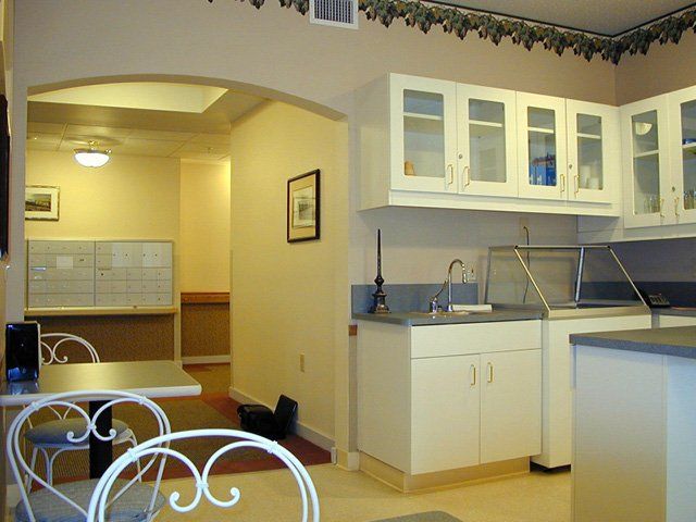 A clean and bright kitchen interior with white cabinets and a sink.
