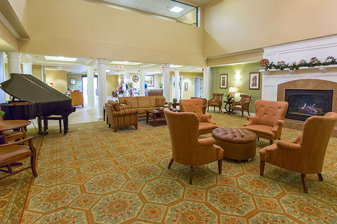 A spacious and well-furnished lobby with a seating area and a piano.