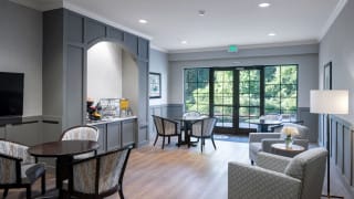A cozy cafe interior with modern furniture and large windows.