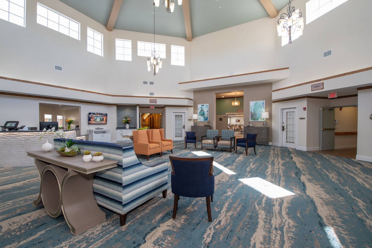 A spacious and elegantly decorated lobby with comfortable seating and modern chandeliers.