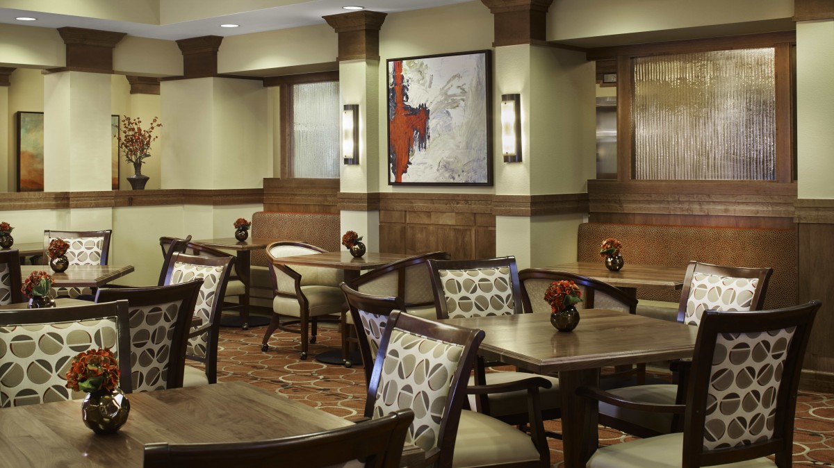 A stylish restaurant interior with elegant seating and artwork on the walls.