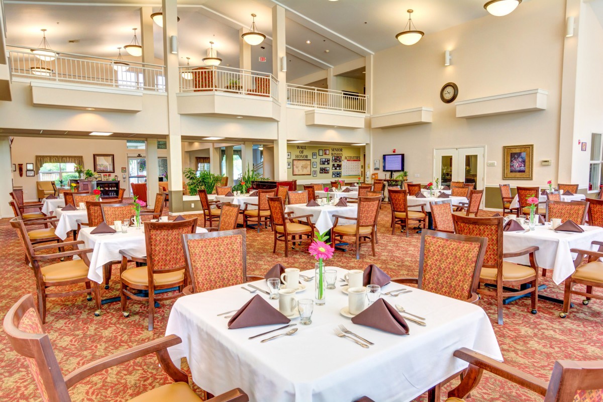 A spacious and elegantly designed dining area with neatly arranged tables and chairs.