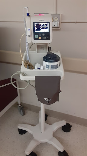 A medical cart equipped with monitoring devices in a hospital environment.