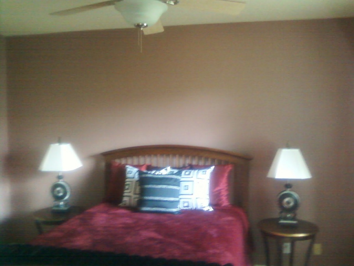 Cozy bedroom with a double bed, two bedside lamps, and a ceiling fan.