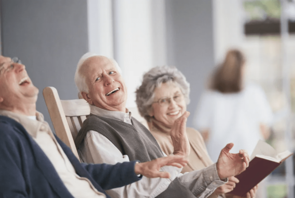 A group of elderly people enjoying their time together, sharing laughter and smiles.