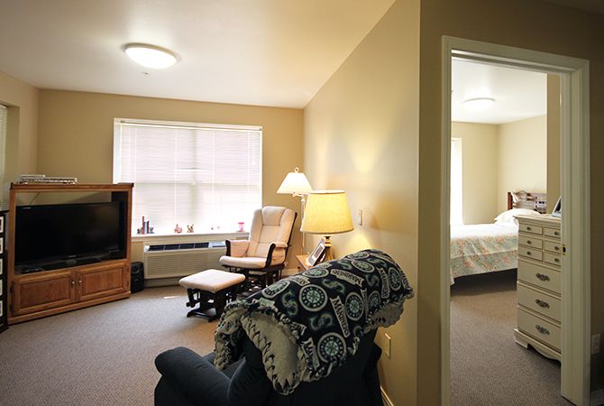 A cozy living room with comfortable seating and warm lighting.