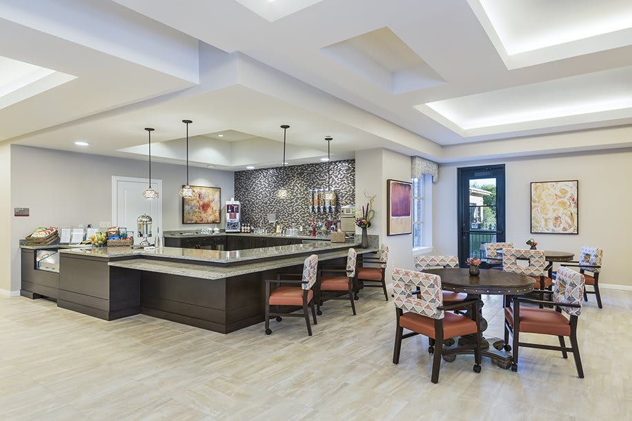Modern kitchen and dining area with stylish lighting and seating arrangements.