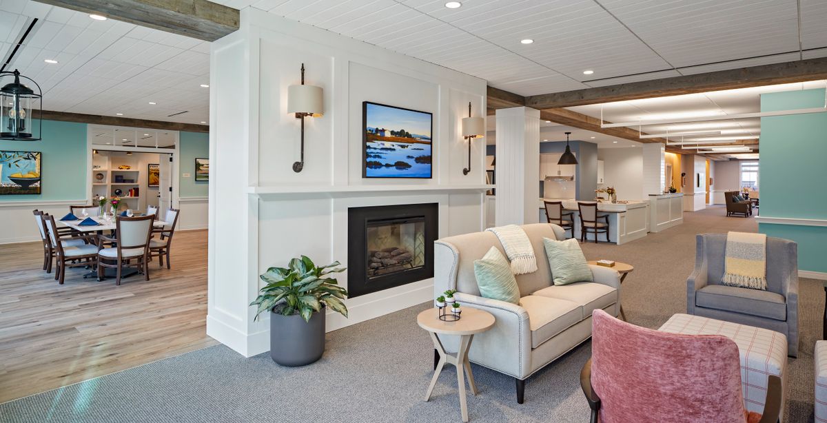 A modern living room with a fireplace, stylish sofa, and elegant lighting.