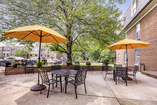 A cozy outdoor patio area with seating and umbrellas, perfect for enjoying the sunshine.