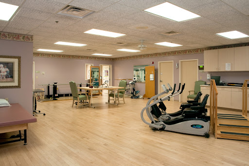 A spacious gym area equipped for rehabilitation and fitness activities.
