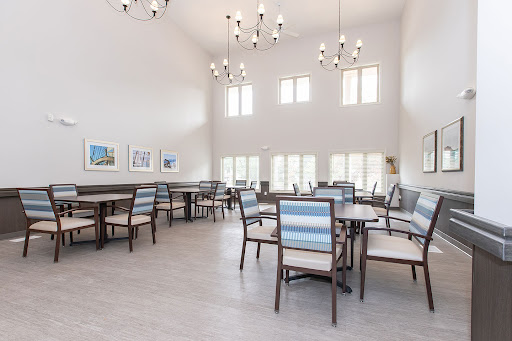 A spacious modern dining area with high ceilings and ample natural light.
