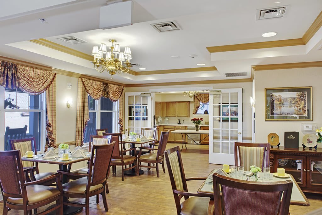 An elegant dining room featuring sophisticated decor with neatly arranged tables and chairs.