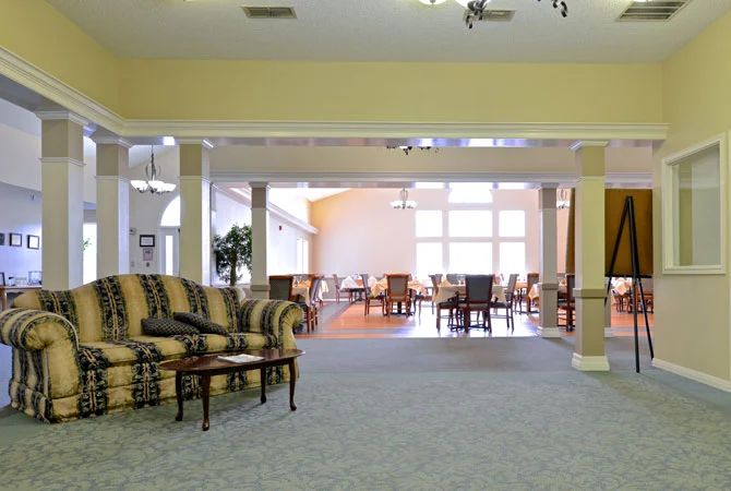 A spacious lobby area with comfortable seating and large windows letting in natural light.