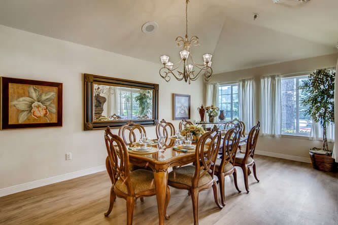 Elegant dining room with a chandelier and wooden furniture.