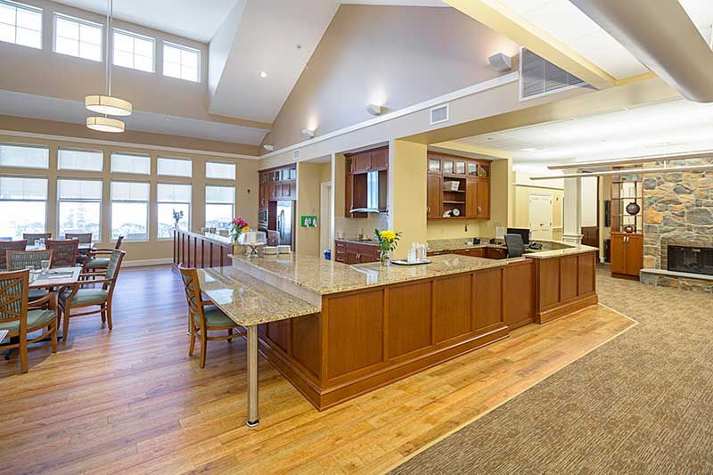 Modern kitchen and dining area with open space and wood flooring.