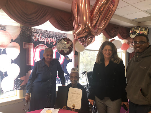 A joyful celebration marking a remarkable 100 years of life surrounded by loved ones.