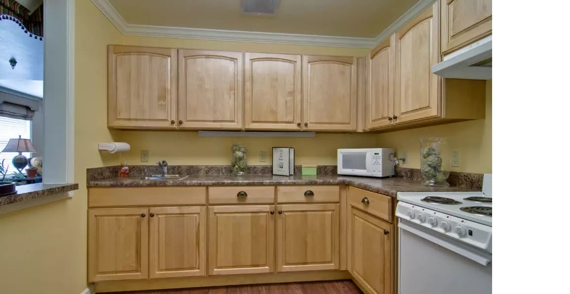 A cozy kitchen featuring light wooden cabinets and modern appliances.