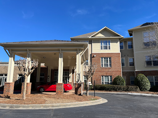 A welcoming residential building with a covered entrance and clear blue sky.