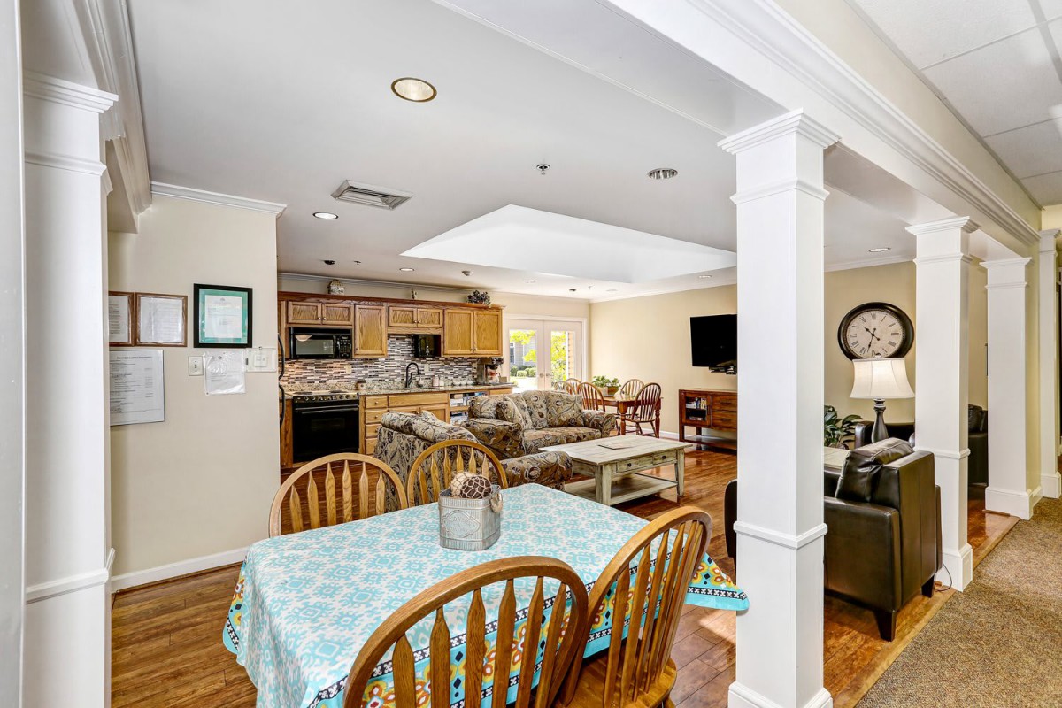 An open concept living space featuring a kitchen, dining area, and cozy living room.