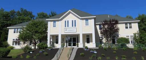 A modern office building with a welcoming entrance and well-maintained landscaping.