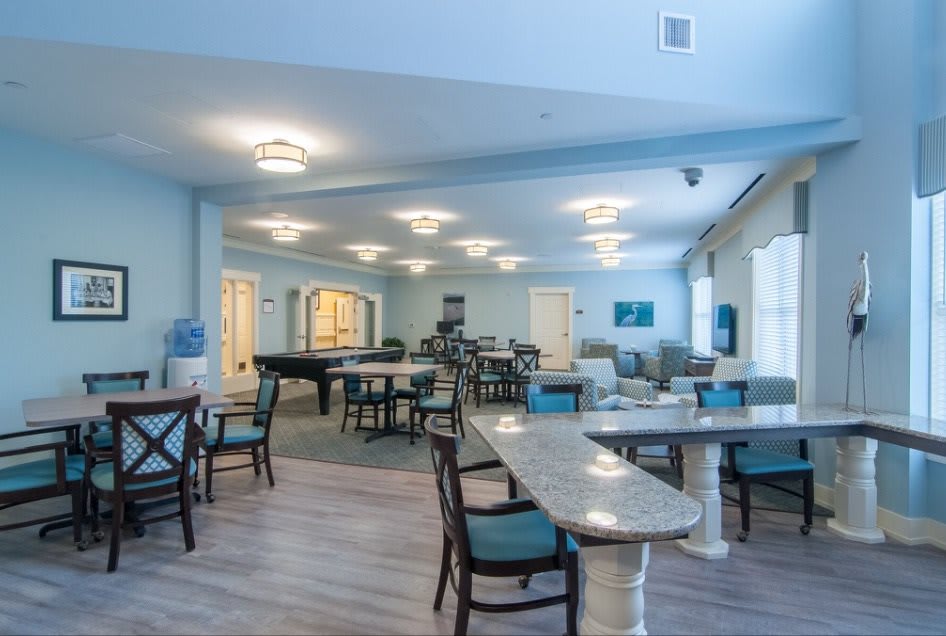 A spacious and well-lit dining area with modern furniture and decor.