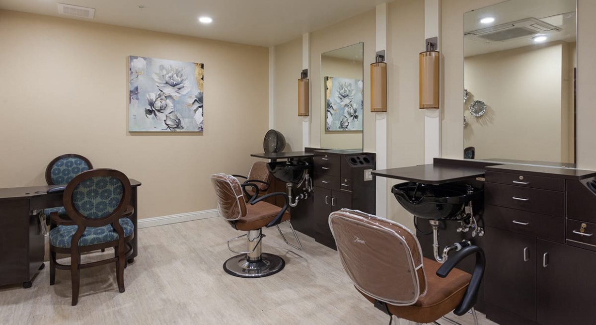 A modern hair salon interior with styling chairs and mirrors.
