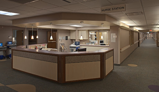 A view of a nurse station in a hospital, featuring a modern and organized reception area.