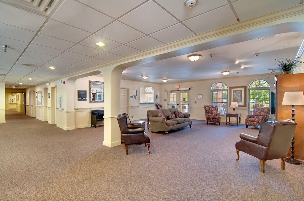 A spacious living area with comfortable seating and warm lighting.