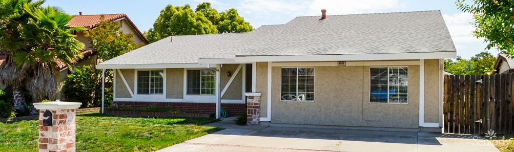 A suburban residential house with a front yard.