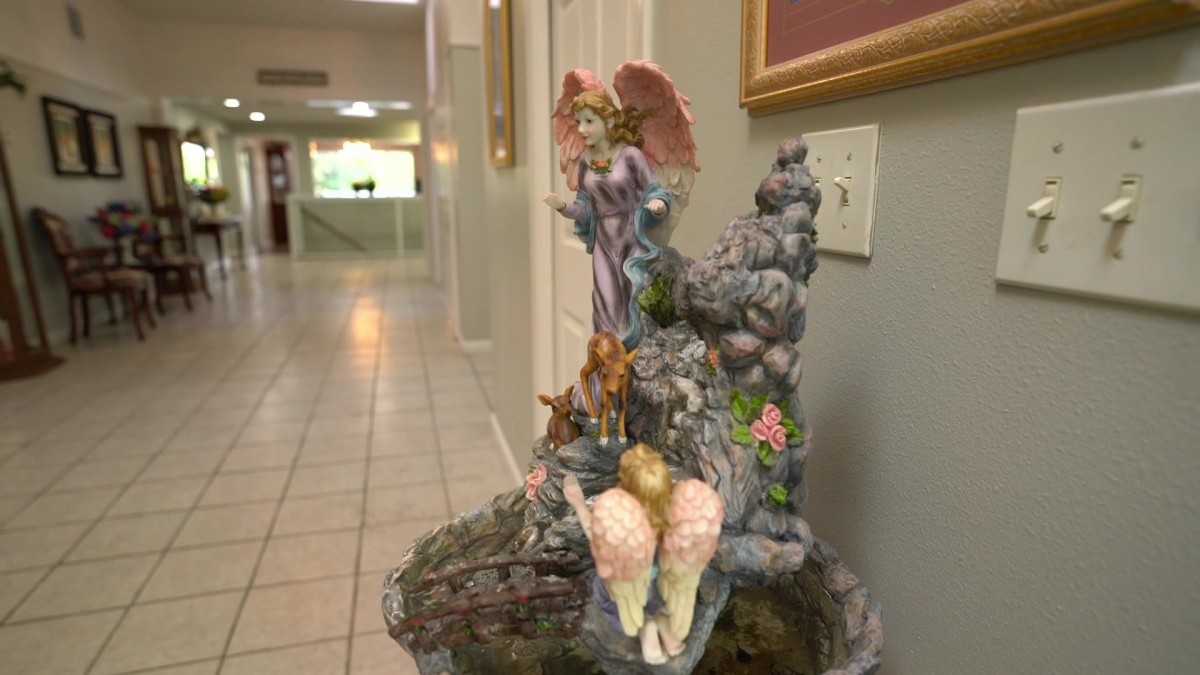 A colorful fairy figurine decorates a hallway.