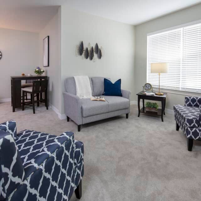 A modern living room with comfortable seating and stylish decor.