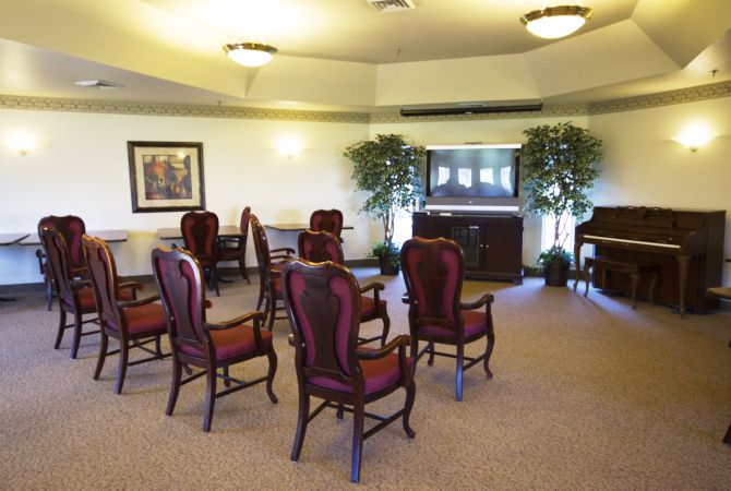 A well-arranged conference room with elegant chairs and a warm atmosphere.