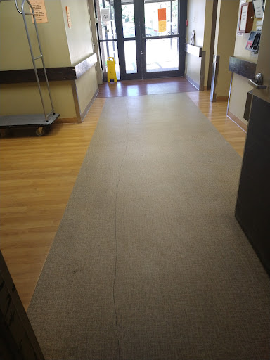 A view of the corridor leading to an entrance in a facility.