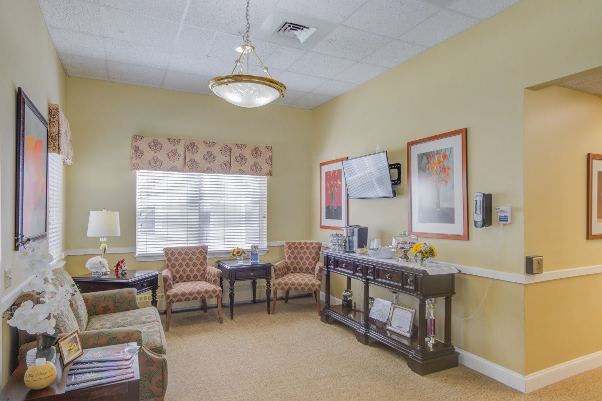 A cozy living room with elegant decor, featuring comfortable seating and warm lighting.