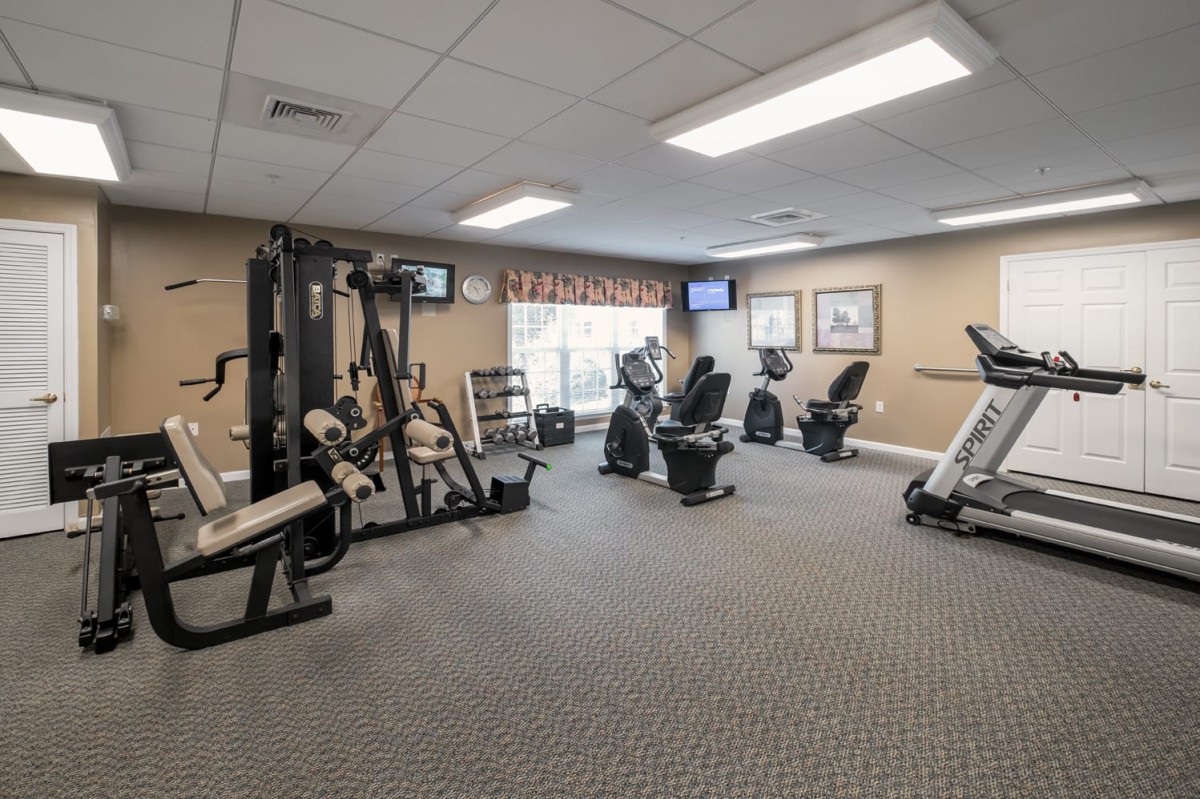 A well-equipped indoor gym with various types of fitness equipment and workout machines.