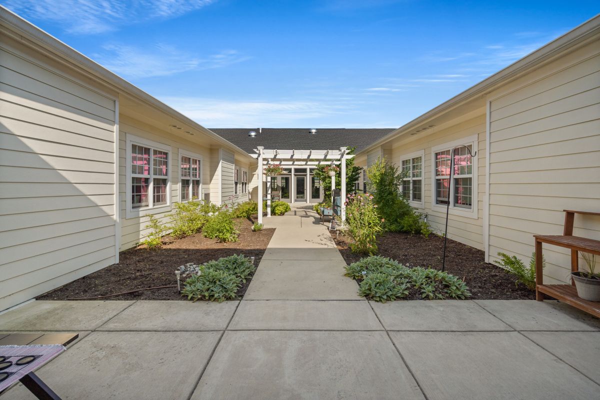 A view of a building's exterior with a landscaped pathway leading to the entrance.