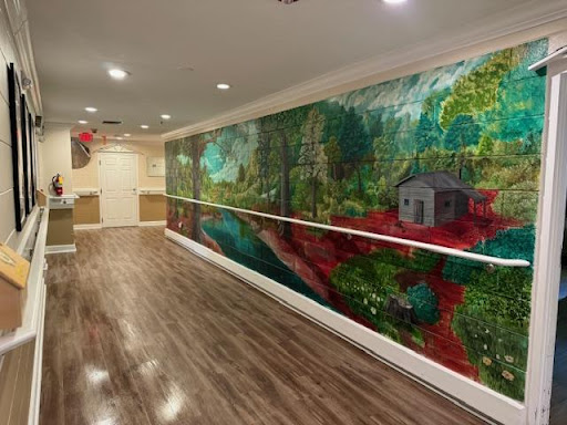 A vibrant mural depicting a serene natural landscape, adding color and life to the interior space.