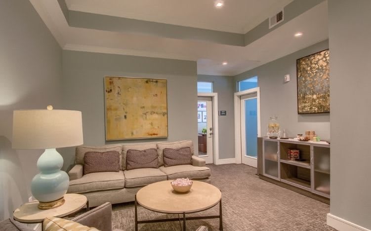 A modern living room featuring a comfortable sofa, stylish coffee table, and contemporary artwork.