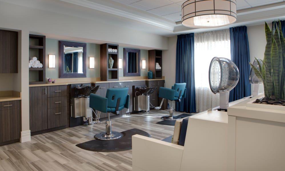 A modern hair salon with stylish chairs and mirrors.
