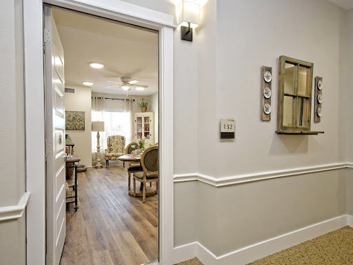 A view from the hallway leading into a warmly lit living space, featuring modern decor and wooden flooring.