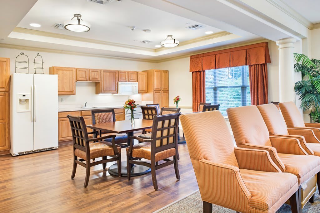 A spacious kitchen and dining area with wooden cabinets and comfortable seating.
