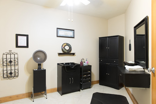A well-organized room featuring black furniture and minimalist decor.