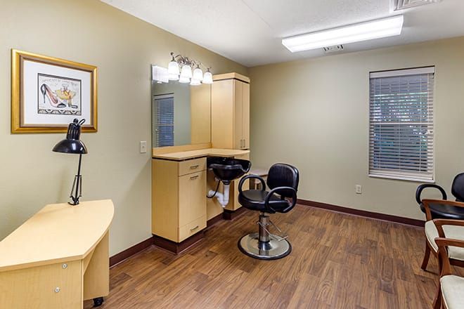A well-organized beauty salon with a styling station and comfortable seating.